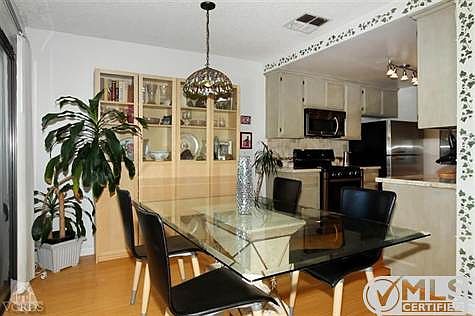 Dining area off of Kitchen will includes ceiling lamp. The sliding glass door leads to balcony and View of mountains.