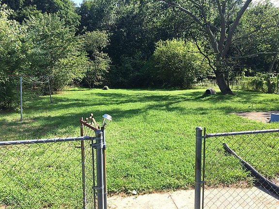 Back yard view from driveway. The tree to the right has been removed.