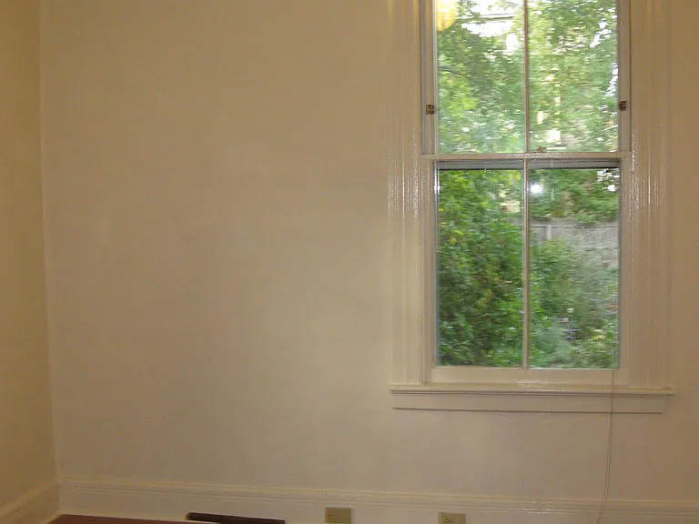 Bedroom view onto side yard. Room measures 10' x 11' with a 4' x 6' extension