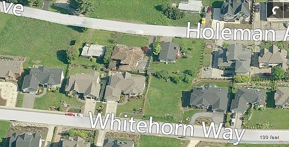 Between yellow n gray house 