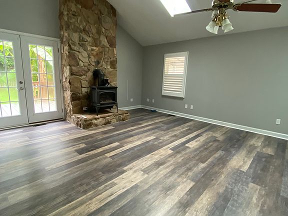 Huge living room with gas stove to keep warm during the winter. Tons of light through the two skylights, windows, and patio doors!