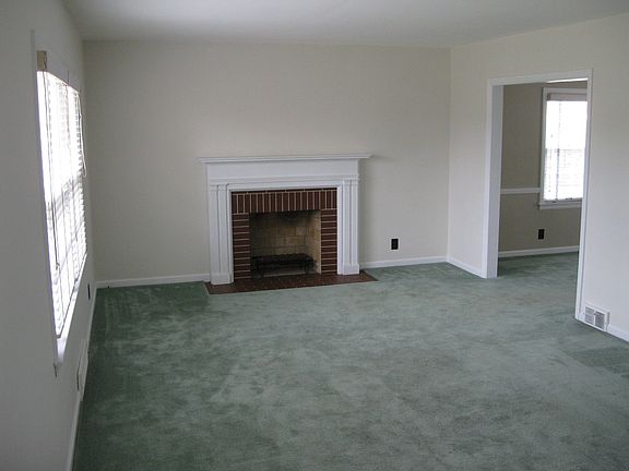 Living room, fire place, dining room entrance on right.
