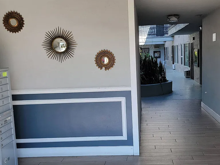 Front entry at The Carlton with mailboxs and courtyard in Hollywood, California.