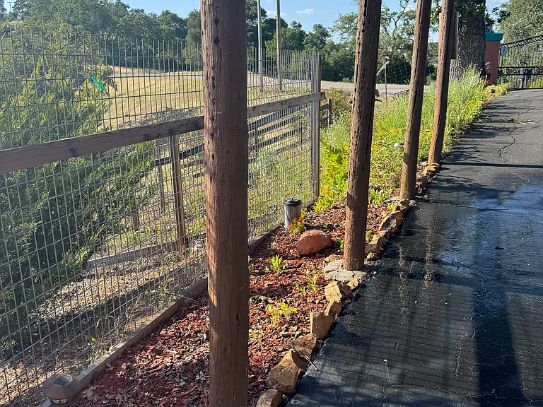 fenced area along covered carport