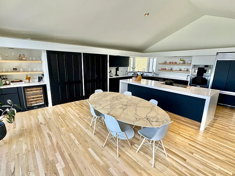 Kitchen/Dining room with 96" Knoll Sarinaan table and Eames dining chairs.