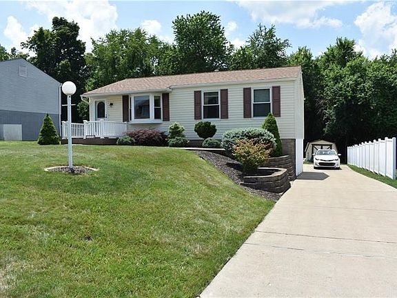 The concrete driveway leads to the rear entry 1 car garage and shed.