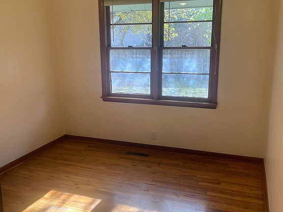 New ceiling fan in bedroom, window view of yard