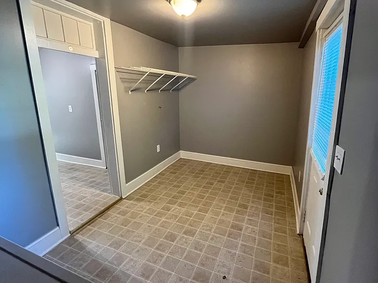 Laundry/storage room, rear entrance to the right.