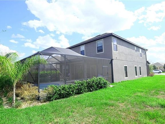 Backyard with Screened Pool and Entertainment Area.