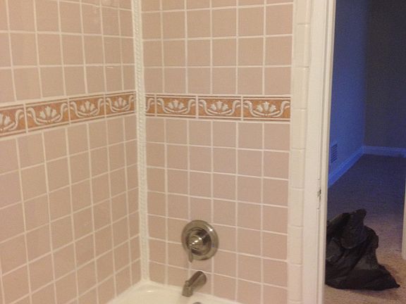 Upstairs new faucet/tiled bath 1