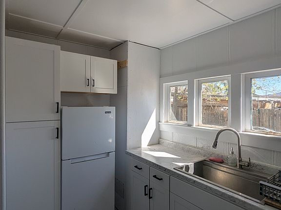 Remodeled kitchen includes loads of storage, refrigerator and oven