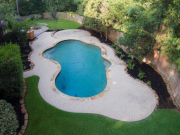 Pool with custom gray plaster for a deeper blue hue. Fully landscaped.