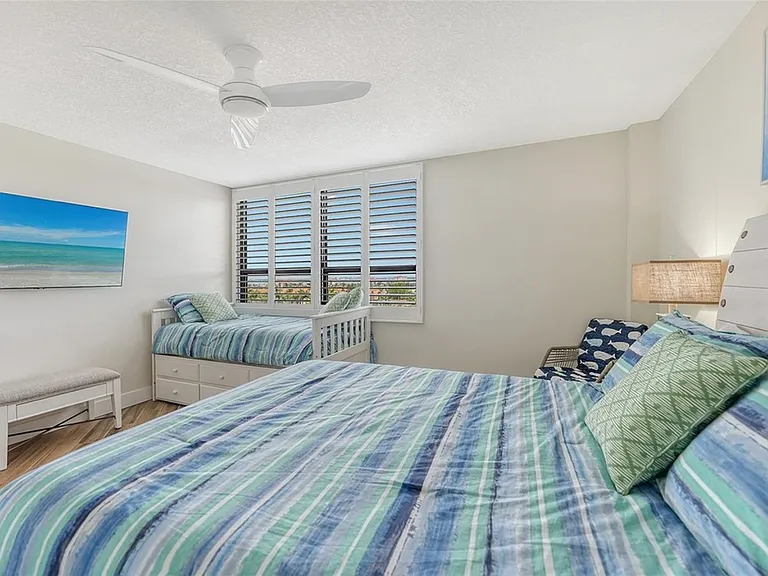 Secondary bedroom queen and trundle beds, sleeps four with walk-in closet, water views and large TV.