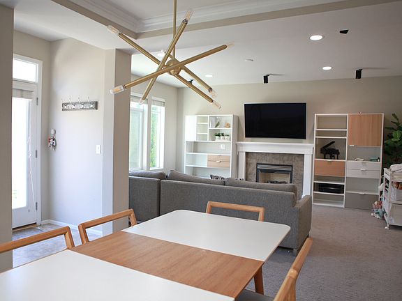 Open Dining and Living Area View - Seamless transition from dining to living space, showcasing natural light and a central fireplace.