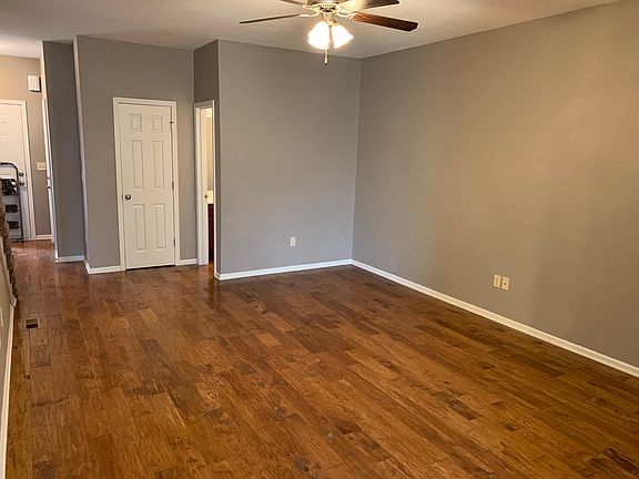 Living room with hardwood floors and half bath