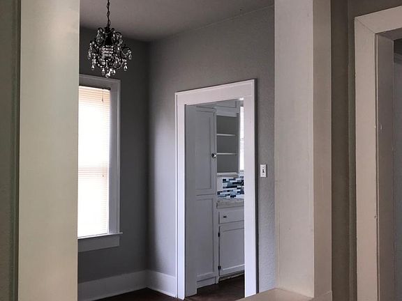 View from hallway into dining room with new chandelier.
