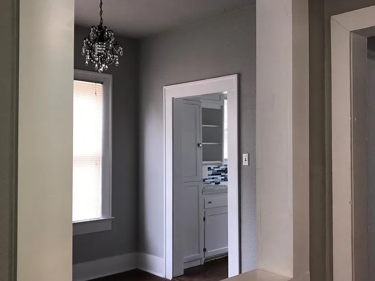 View from hallway into dining room with new chandelier.