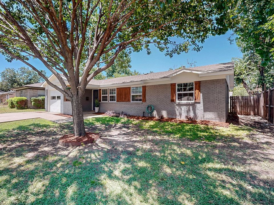 That big shade tree out front? It's even better in person. This yard has the kind of curb appeal that feels welcoming before you even reach the door.