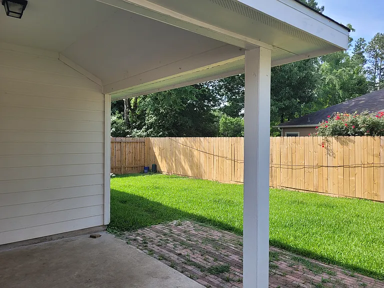 Large lighted back porch, newly fenced back yard.