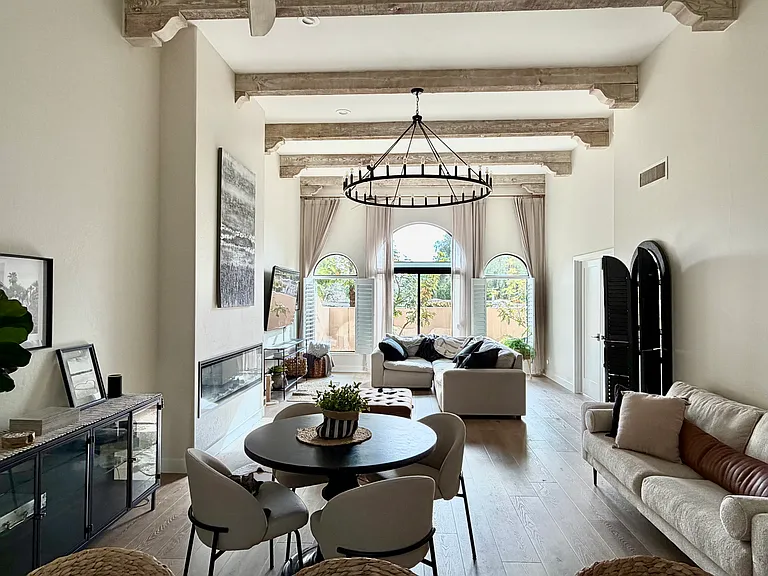 Open living concept family room with 65" swivel flat screen tv, electric faux fireplace, sunscreen shade for room darkening, 2 ceiling fans for extra comfort.