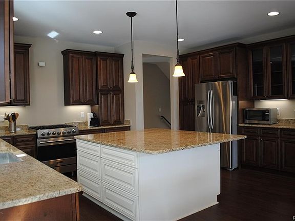 An enormous center island is the focal point of this well-appointed kitchen!