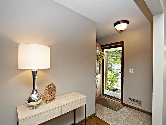 Inviting entry with tile floors and freshly stained original hardwood floors.