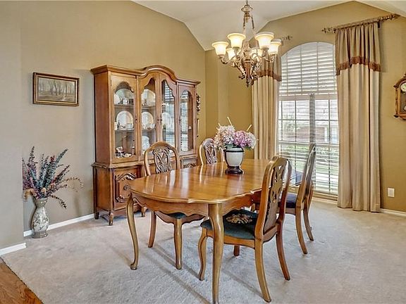 Large formal dining area with custom light fixture
