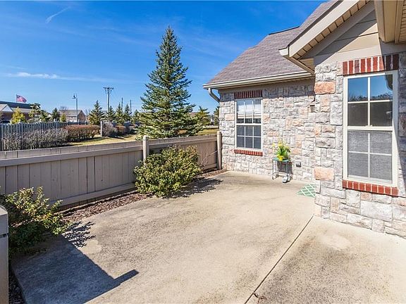Front patio area. I suggest lining the wood fence w/ trees.