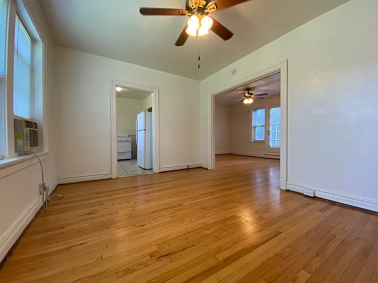 This opposite angle includes the entryway into the kitchen.