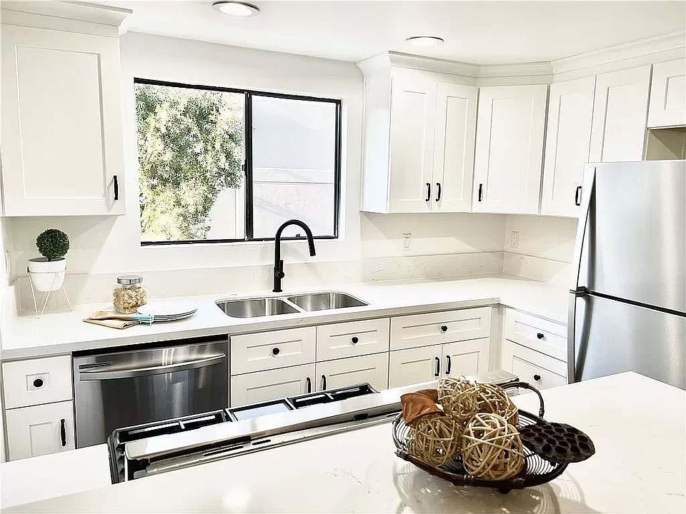 Updated kitchen with new white Shaker cabinets, brand new stainless kitchen appliances and quartz countertops.