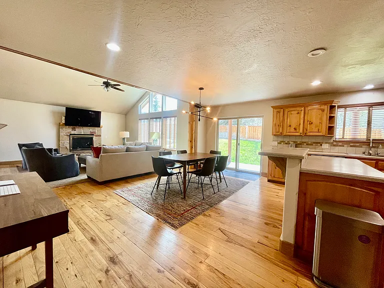 Dining room opens up to large living room with vaulted ceilings
