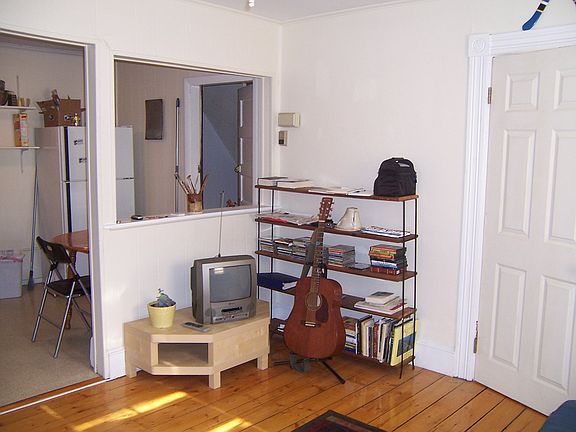 View from Living Room into Kitchen. Wall color is light grey.