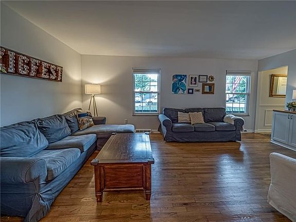 Sun floods the family room and sparkles on the newly stained floors.  Neutral decor is ready for your design.