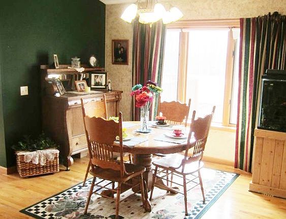 The Dining Room overlooks the back yard, has hard wood flooring and is open to the living room and k