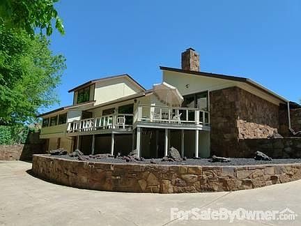 Back of the house
						:
						Shows balcony. Back gate accesses very large city park.