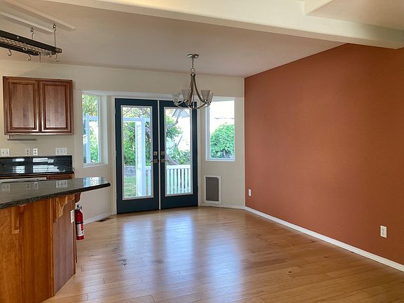 Dining area with French doors to the back porch and fenced yard.