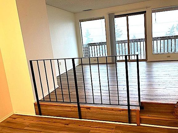 View from main entry to step-up living room and deck overlooking Bellingham Bay
