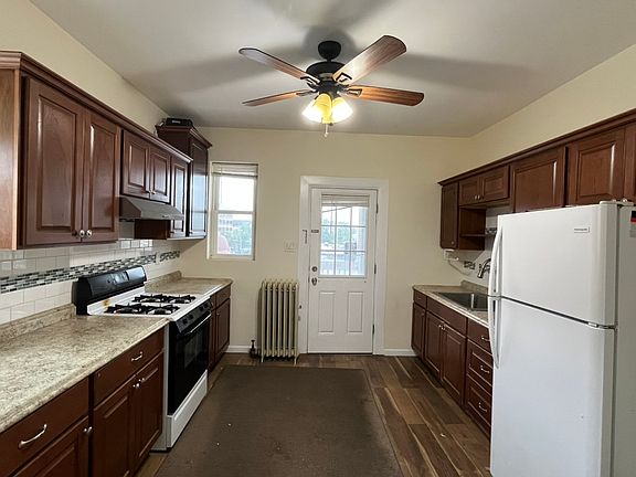 This photo is for apartment 3. Apartment 2 is being renovated and will have new flooring and a new lower sink cabinet and countertop.