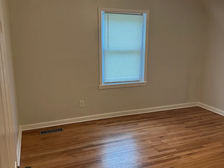 master bedroom with polished hardwood floor. also features ceiling fan with light kit