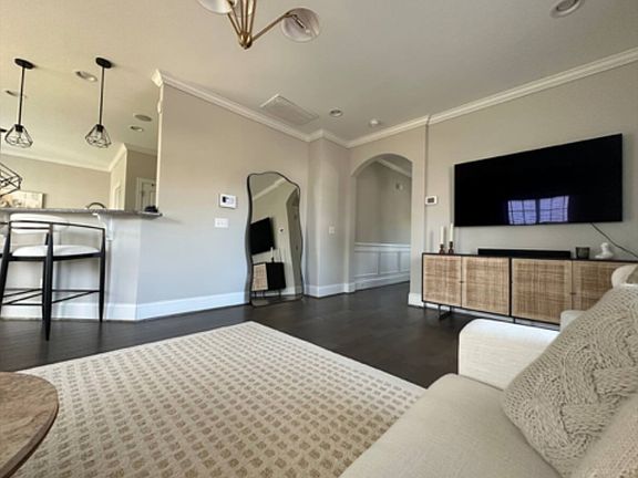 Open concept living room with view of kitchen for entertaining