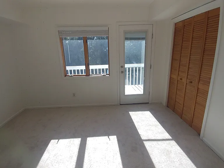 Third floor bedroom with deck facing Pleasure House Lake