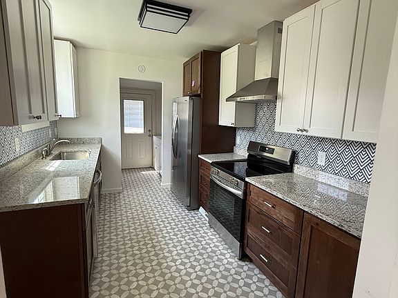 Kitchen as seen from living room. Back door leads to large back deck.