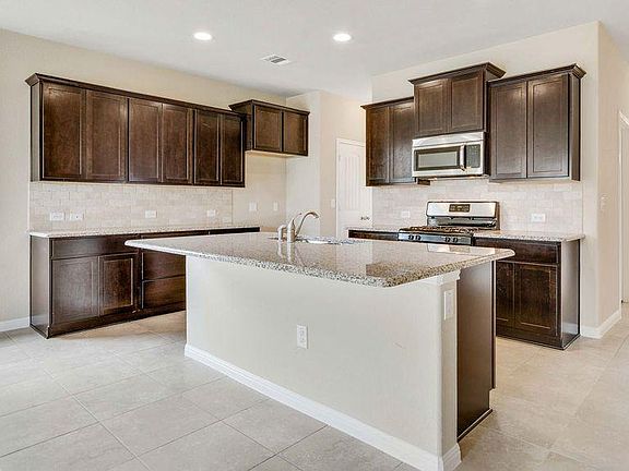 Kitchen includes new (in 2018) stainless steel refrigerator (not shown), tile throughout and 2" blinds on windows (not shown).