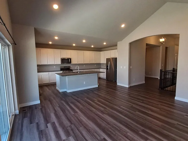 GreatRoom looking at Kitchen. Dining/Living room thru the archway. Double-wide glass patio door on the left.