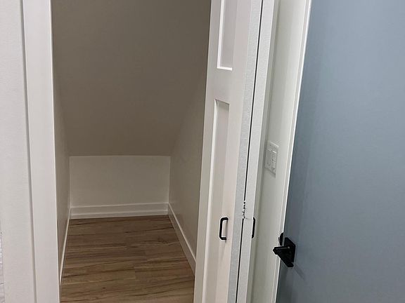 Closet under stairs off the door to the garage