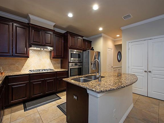 Large island kitchen with double door pantry.