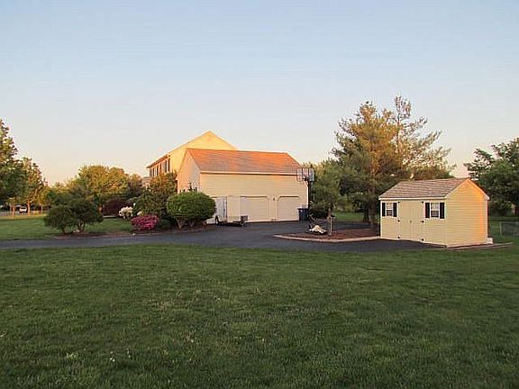 Large 3 car garage, matching drive-through utility shed.