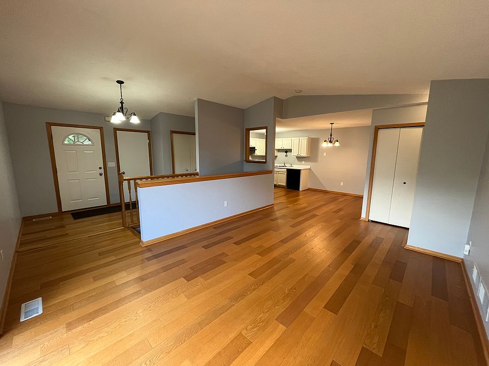 view of living room looking at front door, garage access door, hall closet and kitchen