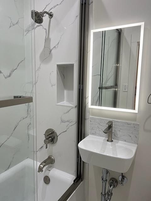 Remodeled bathroom quartz bath surround
