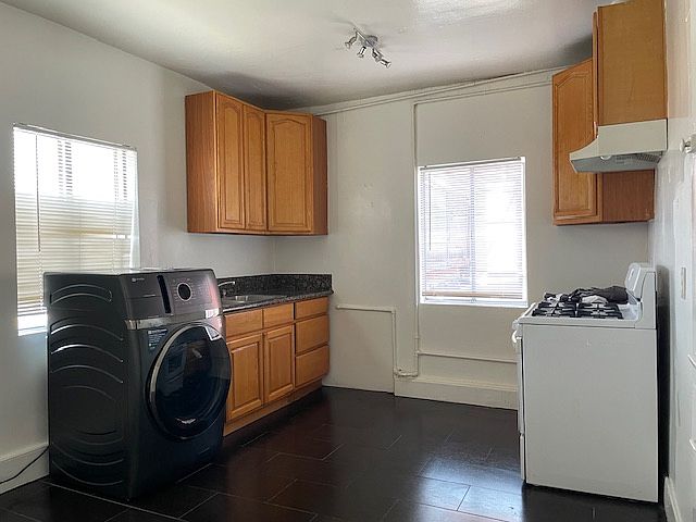 Kitchen area with a Washer and Dryer in one, at the end of the unit, facing secured parking lot.